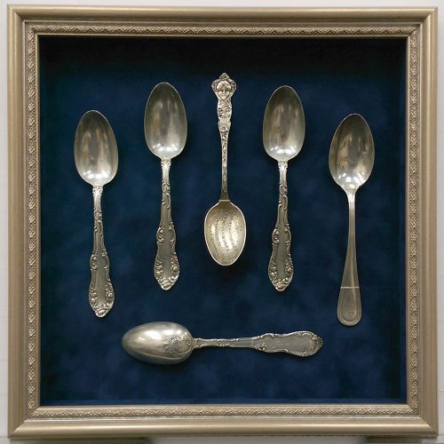 antique spoon collection in a shadowbox